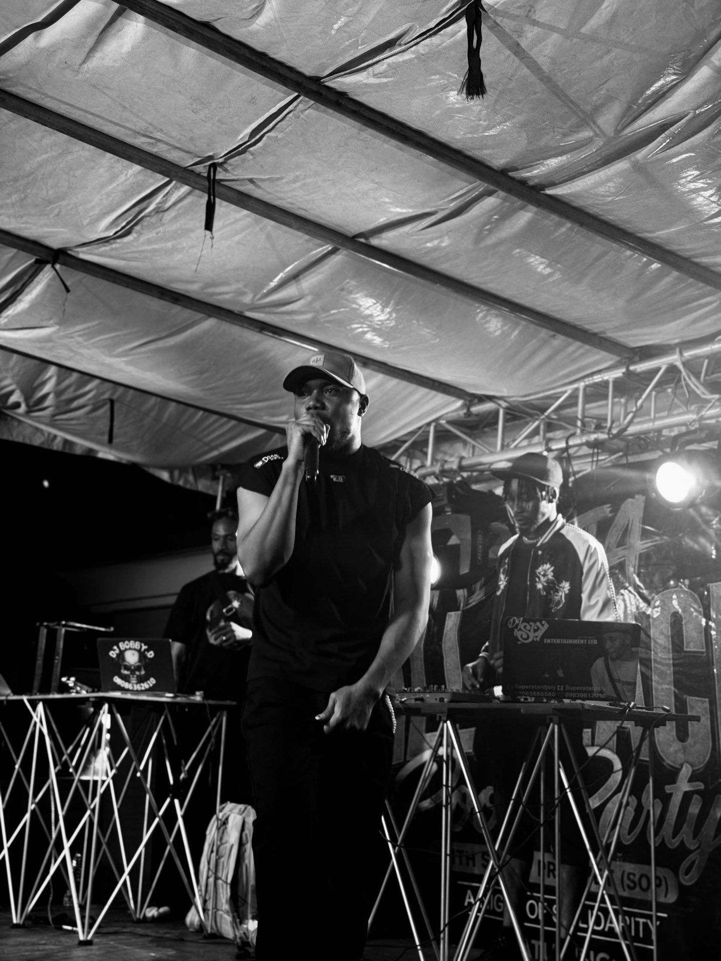 H3RITAGE at the microphone — official editorial black-and-white portrait